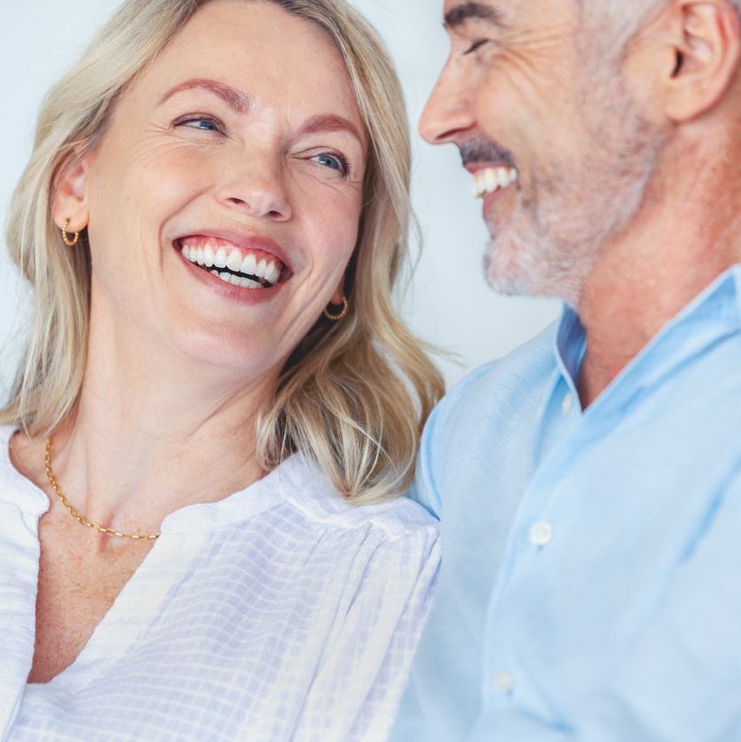 Mature couple embracing on the sofa.