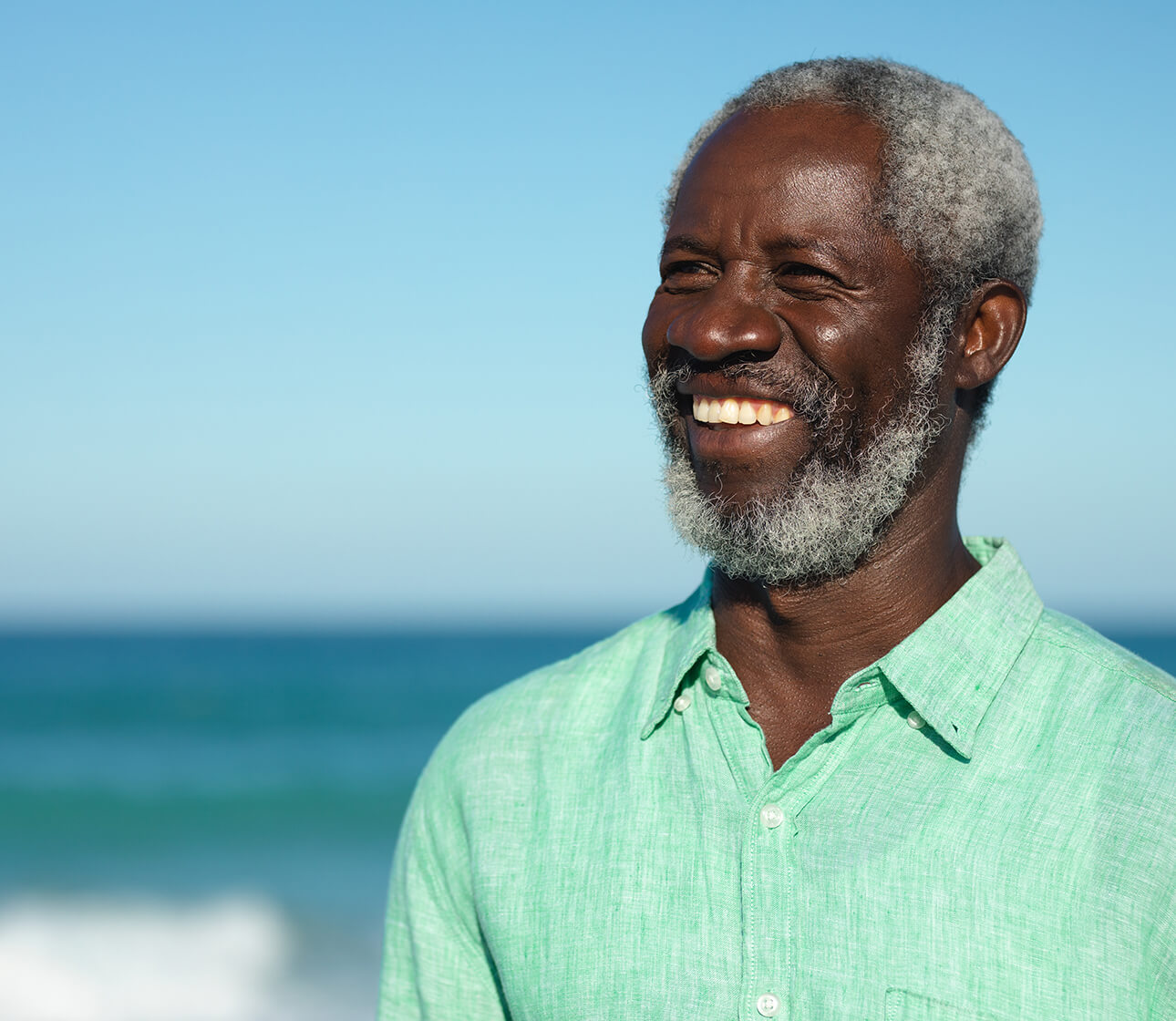 Man smiling by the ocean